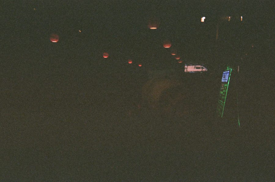 A severely underexposed and grainy image, with faint, ambiguous forms barely visible in the darkness. The limited light creates abstract shapes, making the subject almost indecipherable.