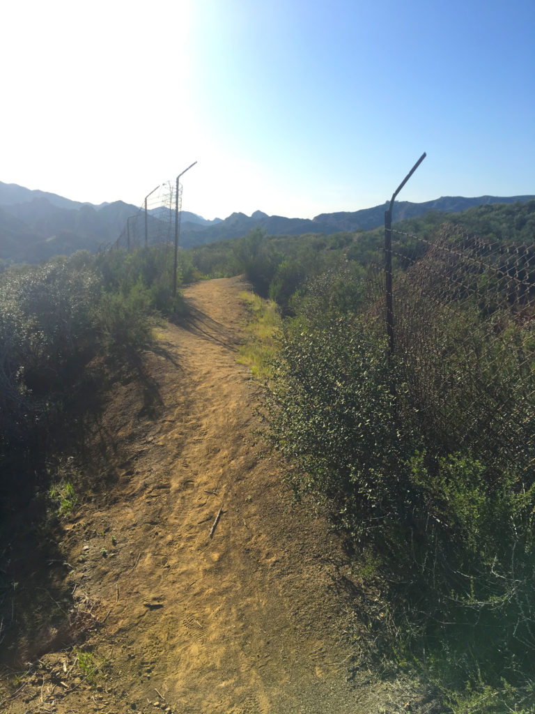 hiking through open fence