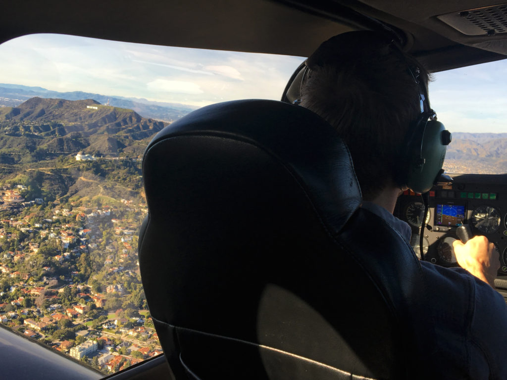 ethan in the cockpit looking out at griffith observatory and the hollywood sign