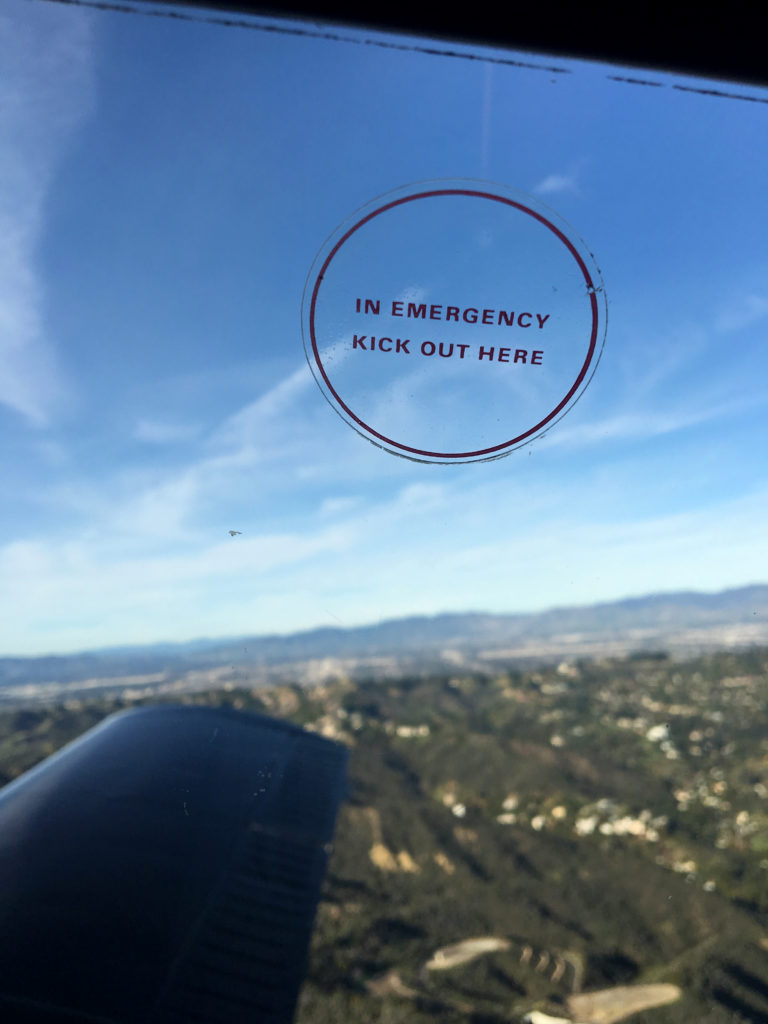 close up on the "in emergency kick out here" window sticker