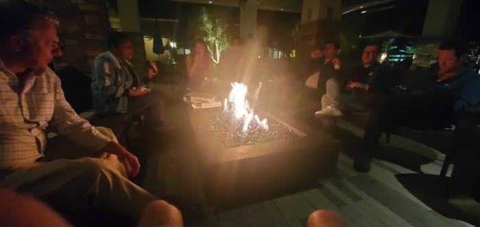 Tipsy digital marketers talking around a fire.