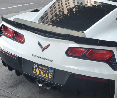 sacr1lg license plate on a white corvette