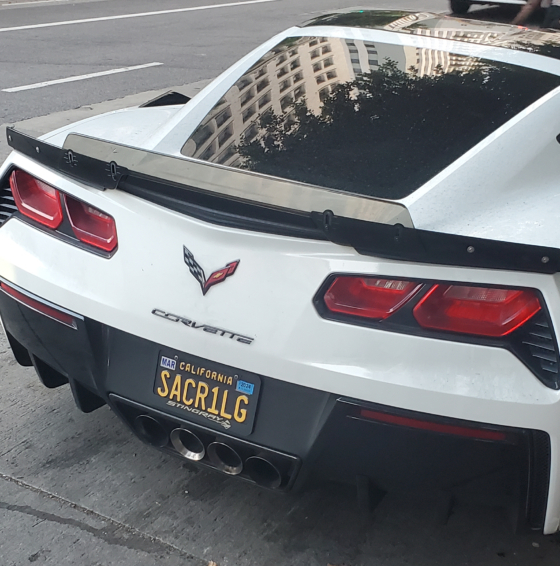 sacr1lg license plate on a white corvette