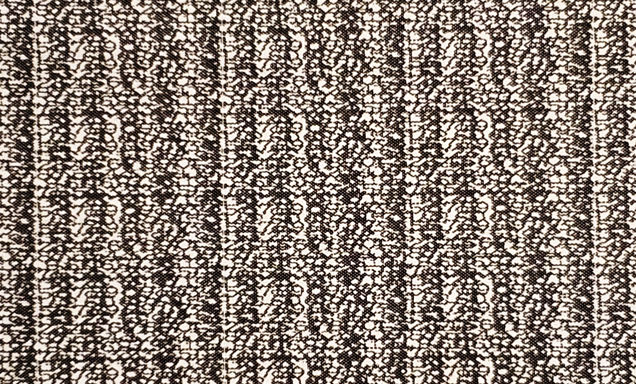 A dense, geometric, repeating design reminiscent of static or lace, or a texture. A security envelope art pattern.